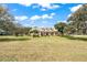 Charming single-story home featuring a manicured lawn and a welcoming front porch at 6206 Ocilla Loop, Clermont, FL 34714