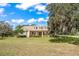 Charming single-story home featuring a manicured lawn and a welcoming front porch at 6206 Ocilla Loop, Clermont, FL 34714