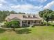 Estate home featuring a charming covered front porch and meticulously landscaped yard at 6206 Ocilla Loop, Clermont, FL 34714