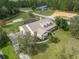 Exterior view of an estate home with a green lawn and a circular driveway at 6206 Ocilla Loop, Clermont, FL 34714