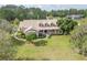 Estate home featuring a charming covered front porch and meticulously landscaped yard at 6206 Ocilla Loop, Clermont, FL 34714