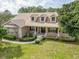 Lovely single Gathering home with dormer windows, columns, and a well-maintained front yard at 6206 Ocilla Loop, Clermont, FL 34714