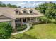 Charming single Gathering home with dormer windows, columns, and landscaped front yard at 6206 Ocilla Loop, Clermont, FL 34714