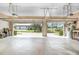 Spacious garage with two bays, concrete floor and view of the grounds outside at 6206 Ocilla Loop, Clermont, FL 34714