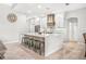 Spacious white kitchen featuring a large center island, stainless appliances, and modern finishes at 6206 Ocilla Loop, Clermont, FL 34714