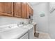 Laundry room with white washer and dryer, cabinets, sink and 