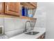 Laundry room sink with modern faucet, quartz countertops and marbled backsplash at 6206 Ocilla Loop, Clermont, FL 34714