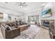 Spacious living room features a stone fireplace and sliding doors to the outdoor pool area at 6206 Ocilla Loop, Clermont, FL 34714