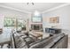 Bright living room with fireplace, sliding glass doors to the pool, and elegant furnishings at 6206 Ocilla Loop, Clermont, FL 34714