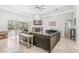 Spacious living room featuring stone fireplace and sliding glass doors to outdoor patio at 6206 Ocilla Loop, Clermont, FL 34714