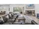 Cozy living room with stone fireplace, leather sectional, and sliding glass doors to the pool area at 6206 Ocilla Loop, Clermont, FL 34714