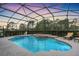 Inviting screened pool with a serene setting, perfect for relaxation and entertainment at 6206 Ocilla Loop, Clermont, FL 34714