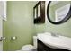 Bathroom features a round mirror, a sink with cabinet, and a toilet at 7036 Clarcona Ocoee Dr, Orlando, FL 32818