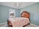 Bright bedroom showcasing a large window, neutral wall color, and tiled floors at 7036 Clarcona Ocoee Dr, Orlando, FL 32818