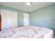 Light and airy bedroom with a ceiling fan, light walls, and closet doors at 7036 Clarcona Ocoee Dr, Orlando, FL 32818