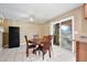 Dining area featuring tile flooring, a ceiling fan and a sliding glass door leading to outdoor area at 7036 Clarcona Ocoee Dr, Orlando, FL 32818