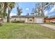 Inviting home front exterior, with an attached garage and well-maintained lawn at 7036 Clarcona Ocoee Dr, Orlando, FL 32818