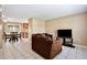 Cozy living room featuring tile floors and neutral walls, adjacent to the dining area at 7036 Clarcona Ocoee Dr, Orlando, FL 32818