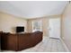 Comfortable living room featuring tile flooring, neutral walls, and a large window for natural light at 7036 Clarcona Ocoee Dr, Orlando, FL 32818