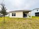 Backyard view of the home, complete with a covered patio at 726 Eagle Landing Blvd, Winter Haven, FL 33880