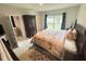 Cozy bedroom featuring a queen size bed and dark wood armoire at 726 Eagle Landing Blvd, Winter Haven, FL 33880