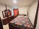 Comfortable bedroom featuring a four-poster bed, matching dresser and bedside tables at 726 Eagle Landing Blvd, Winter Haven, FL 33880