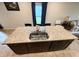 Kitchen island featuring a granite countertop, sink, and dining space at 726 Eagle Landing Blvd, Winter Haven, FL 33880