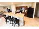 Kitchen featuring a large island with bar seating, granite counters, and black appliances at 726 Eagle Landing Blvd, Winter Haven, FL 33880