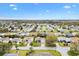 Neighborhood aerial view highlighting the property with a red star, showing its well-manicured lawn at 8425 Se 177Th Bartram Loop, The Villages, FL 32162