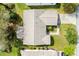 Aerial view of a home with a well maintained roof, lawn, landscaping, and long driveway at 8425 Se 177Th Bartram Loop, The Villages, FL 32162