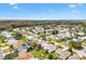 A neighborhood aerial view emphasizes a home's location with mature trees and landscaping at 8425 Se 177Th Bartram Loop, The Villages, FL 32162