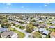 Aerial view with a red star highlighting the property's location near a golf course and lake at 8425 Se 177Th Bartram Loop, The Villages, FL 32162