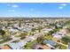 An aerial view shows the location of the home in a neighborhood with mature trees and landscaping at 8425 Se 177Th Bartram Loop, The Villages, FL 32162