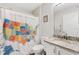 Bathroom featuring a USA map shower curtain, granite countertops, white cabinets, and modern fixtures at 8425 Se 177Th Bartram Loop, The Villages, FL 32162