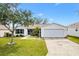 Charming single-story home with a two car garage, manicured lawn, and inviting front porch at 8425 Se 177Th Bartram Loop, The Villages, FL 32162