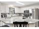 Well-lit kitchen with granite counters and stainless steel appliances at 8425 Se 177Th Bartram Loop, The Villages, FL 32162