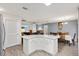 Kitchen island with seating, overlooking the living and dining areas at 8425 Se 177Th Bartram Loop, The Villages, FL 32162