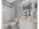 Well-lit bathroom featuring a shower-tub combo and vanity with a large mirror at 906 Calabria Ave, Davenport, FL 33897