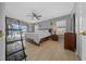 Bright bedroom with wood floors, a ceiling fan, and access to an outdoor balcony at 906 Calabria Ave, Davenport, FL 33897