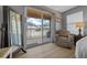 Cozy bedroom featuring sliding glass doors to patio, a comfortable armchair, and stylish decor at 906 Calabria Ave, Davenport, FL 33897