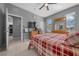 Comfortable bedroom featuring tile flooring, a ceiling fan, and plenty of natural light at 906 Calabria Ave, Davenport, FL 33897