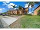 Beautiful townhome featuring tan paint, shutters, a driveway, green lawn, and palm trees at 906 Calabria Ave, Davenport, FL 33897