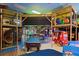 Community game room with an arcade, pool table, and colorful play area at 906 Calabria Ave, Davenport, FL 33897