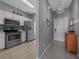 Hallway view leading to the kitchen, featuring modern appliances and stylish cabinets at 906 Calabria Ave, Davenport, FL 33897