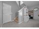 Hallway area with a staircase, storage cabinet, and tiled flooring, adding to the home's charm at 906 Calabria Ave, Davenport, FL 33897