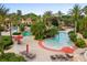 Large community pool with palm trees, lounge chairs, and water features at 906 Calabria Ave, Davenport, FL 33897