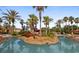 Community swimming pool with lush landscaping and tropical island in the center at 906 Calabria Ave, Davenport, FL 33897