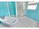 Bright bathroom features a walk-in shower, soaking tub, and white tile floors at 925 Northside Dr, Mount Dora, FL 32757