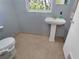 Half bathroom features a pedestal sink and toilet at 925 Northside Dr, Mount Dora, FL 32757