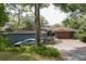Charming single-story home with lush landscaping, driveway, and a modern garage door at 925 Northside Dr, Mount Dora, FL 32757